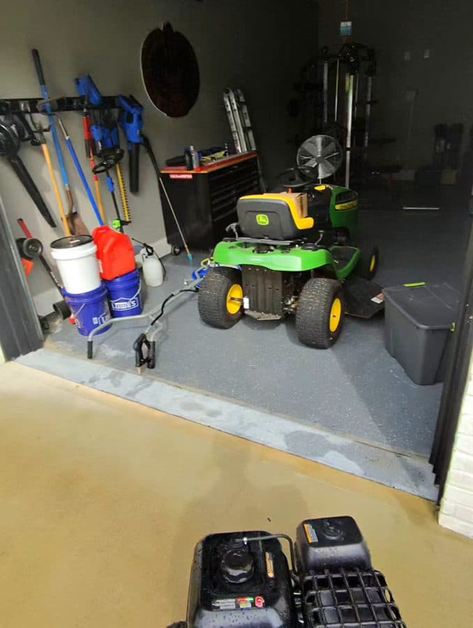 Garage and pressure washing equipment staged before exterior cleaning work