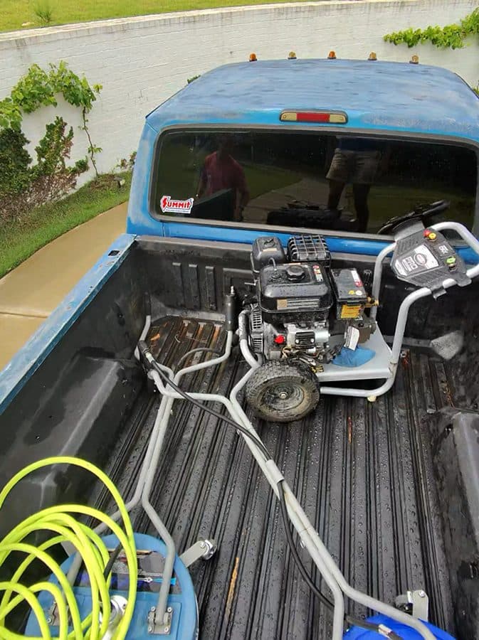 Pressure washing equipment loaded in a truck bed