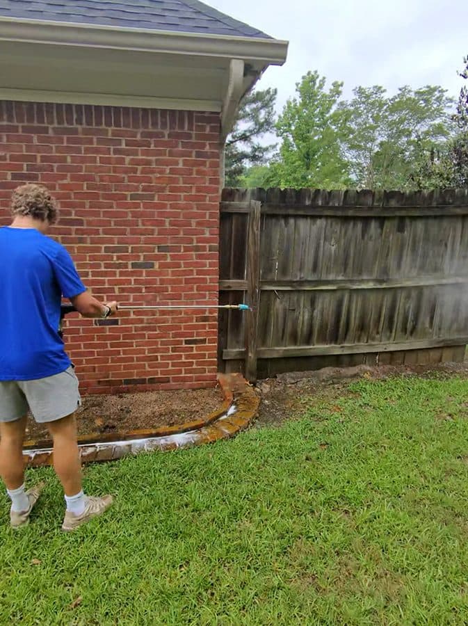 Team Clean washing down a brick home exterior in the Columbus GA area
